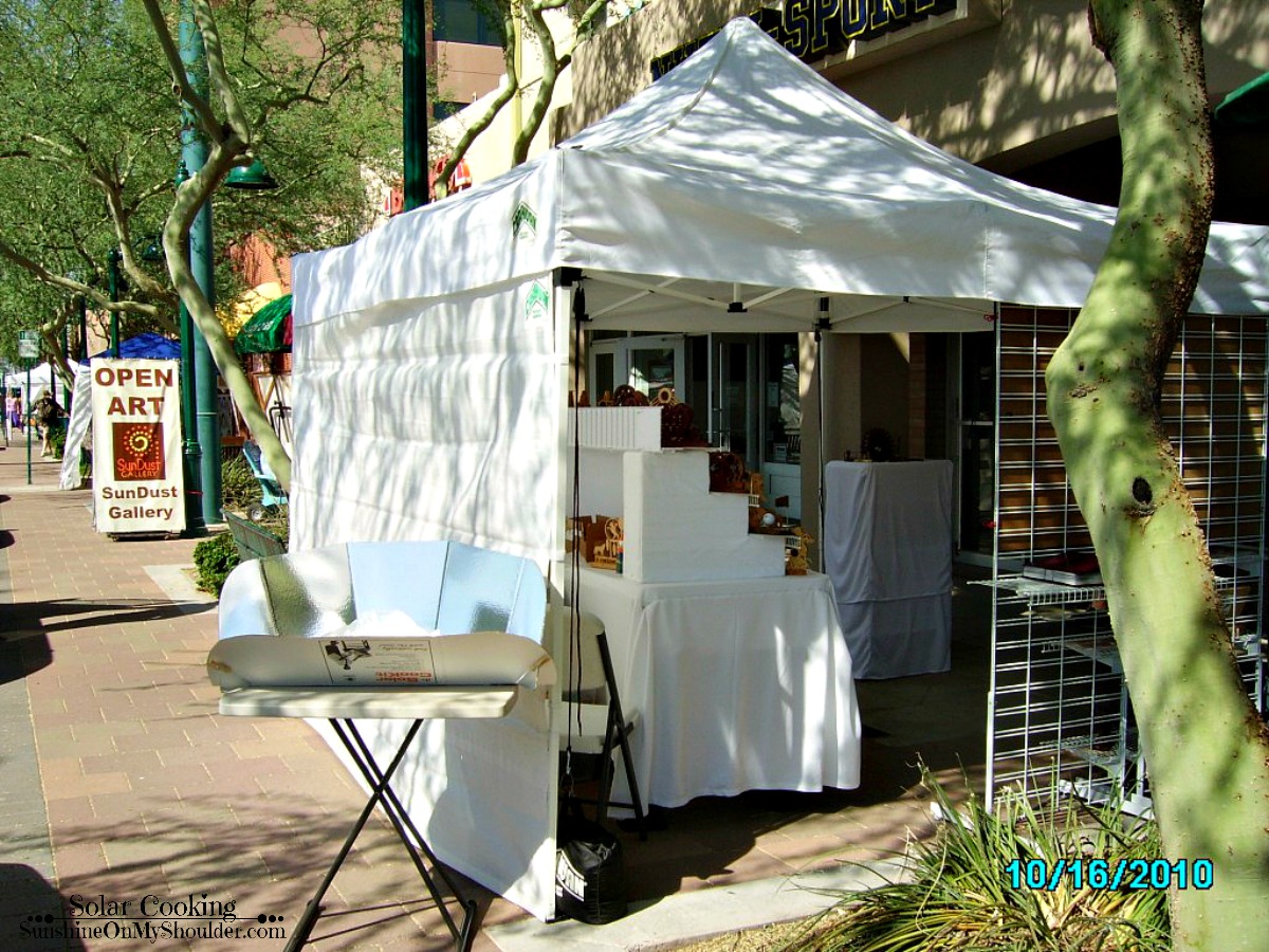 Craft show booth with solar cooker