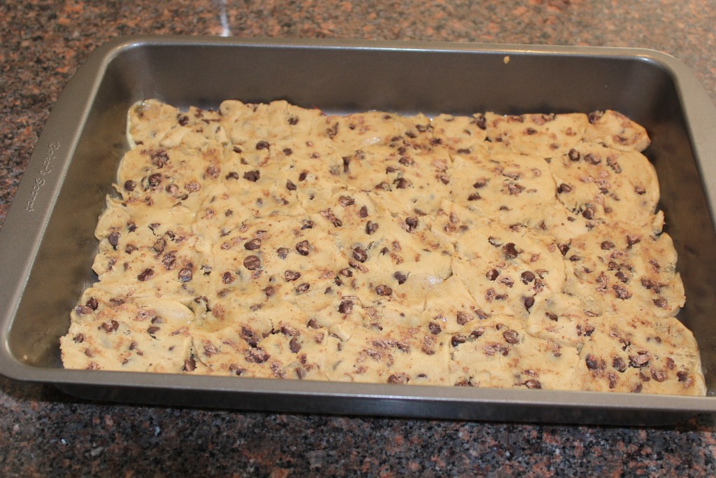 Refrigerated chocolate chip cookie dough pressed into pan.
